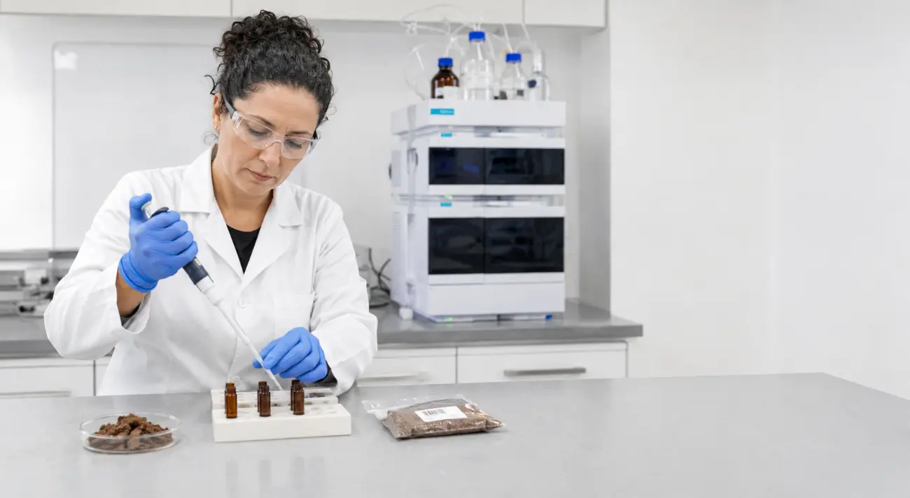 Specialist testing natural health-product samples in a bright quality-control laboratory